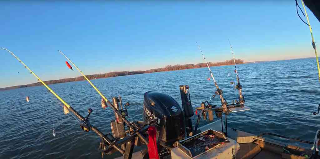 Six rods equipped with floats spread out on a boat’s stern during a winter catfishing session.