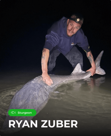 Ryan Zuber landing a trophy sturgeon at night using a Catch the Fever heavy-power rod
