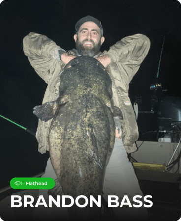Brandon Bass holding a fish caught using Catch The Fever® fishing rods.